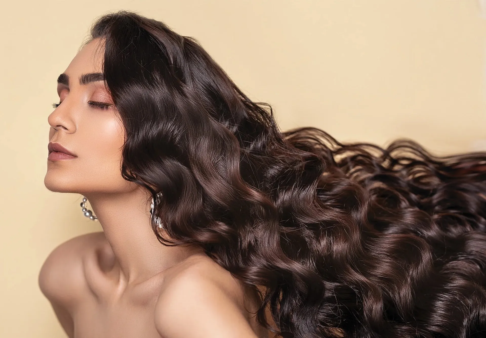 Long, glossy curls styled with organic colour at Natural Shine Hair & Beauty, an organic hair salon in North Kellyville